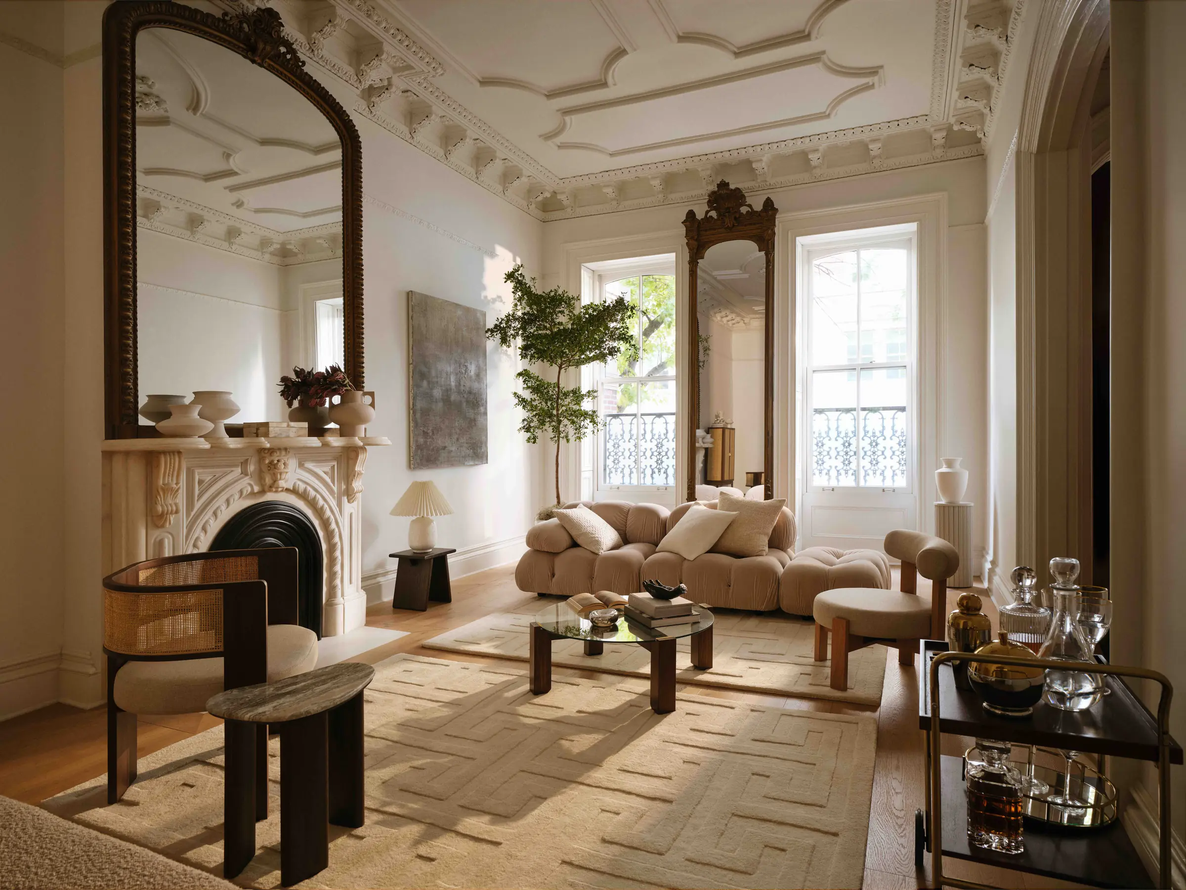 Townhouse parlour with ornate plaster ceiling, marble fireplace, cream boucle sofa and patterned rug, for H&M Home.