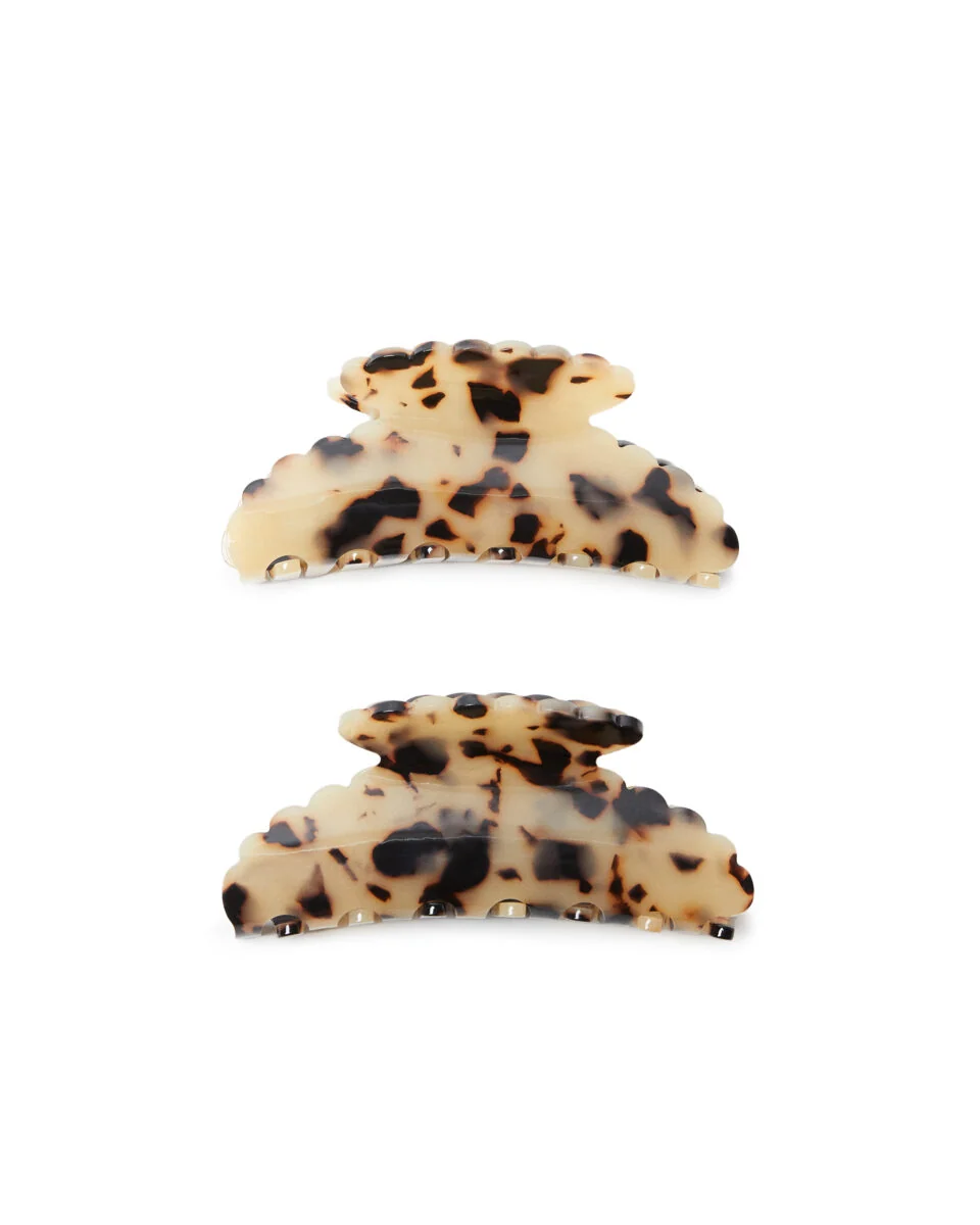 Two blonde tortoiseshell claw hair clips with scalloped edges on a white background, for Loeffler Randall.